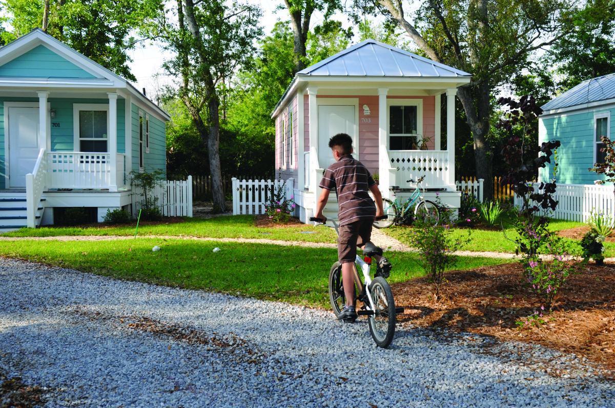 Child riding a bike through a neighborhood